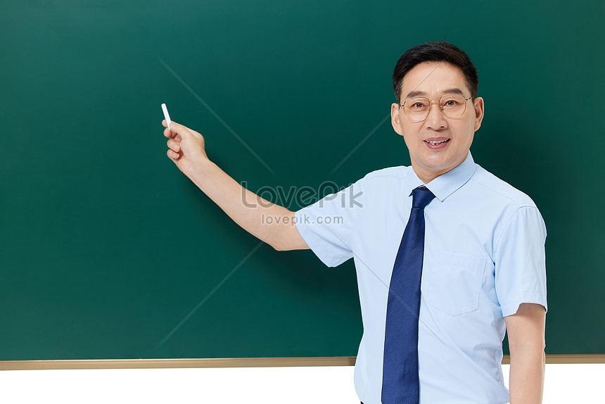 Middle Aged Professor Holds The Chalk In Front Of The Blackboard ...