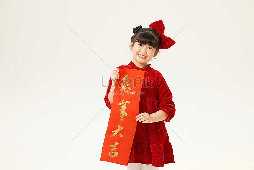 Little Girl In Red Dress Holds Couplets In Both Hands Picture And HD ...